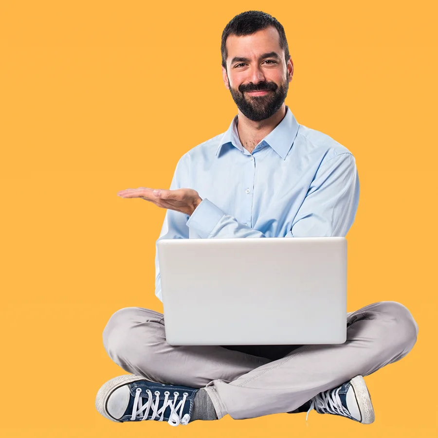 Man holding a laptop, pointing at the screen